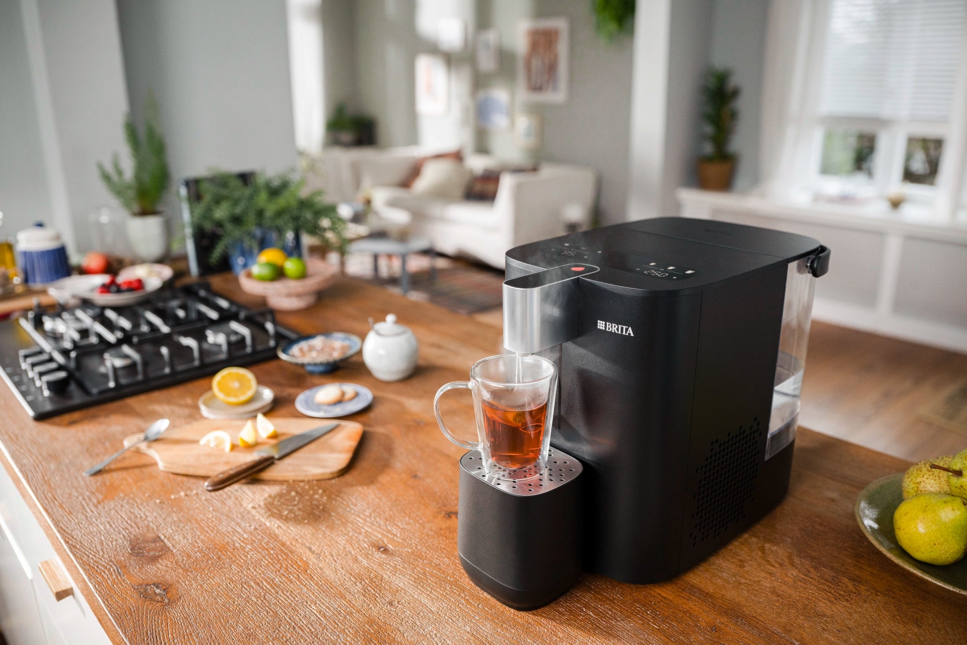 BRITA YOURCE cool water dispenser preparing hot water for tea in a kitchen.