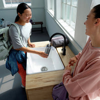 Woman filling BRITA water filter bottle Model Active in gym