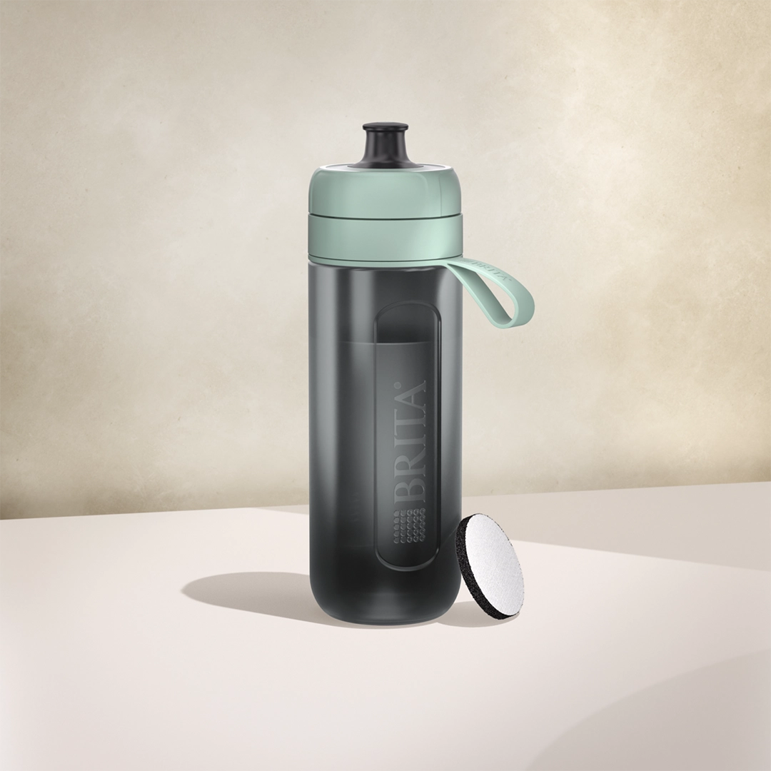 BRITA Active water filter bottle in dark green on a beige background