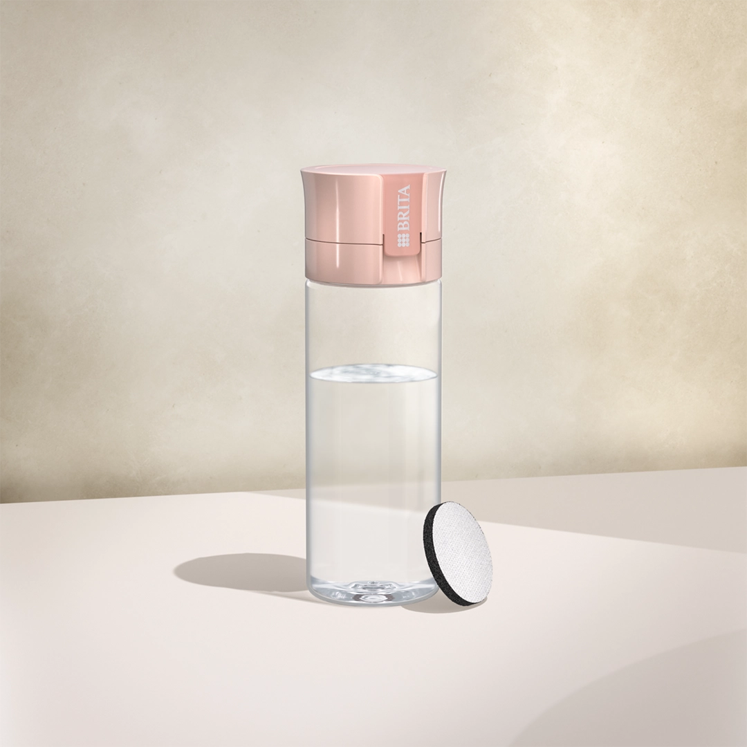 BRITA-water filter Vital-fles in abrikooskleur op een beige achtergrond