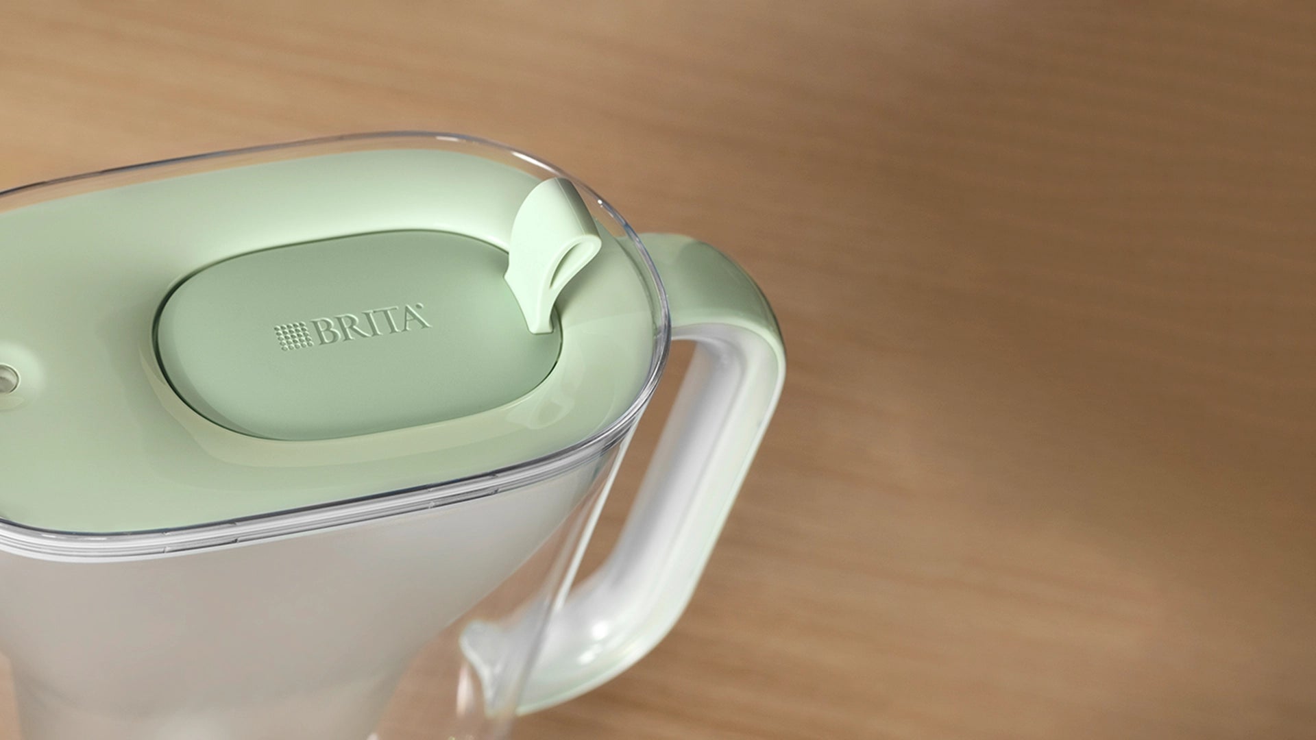 A BRITA Style eco water filter jug lid from above on a wooden surface.