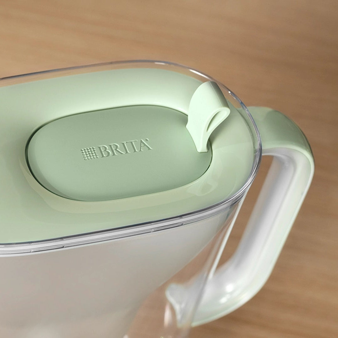 Light green BRITA Style eco water filter jug on a wooden surface.