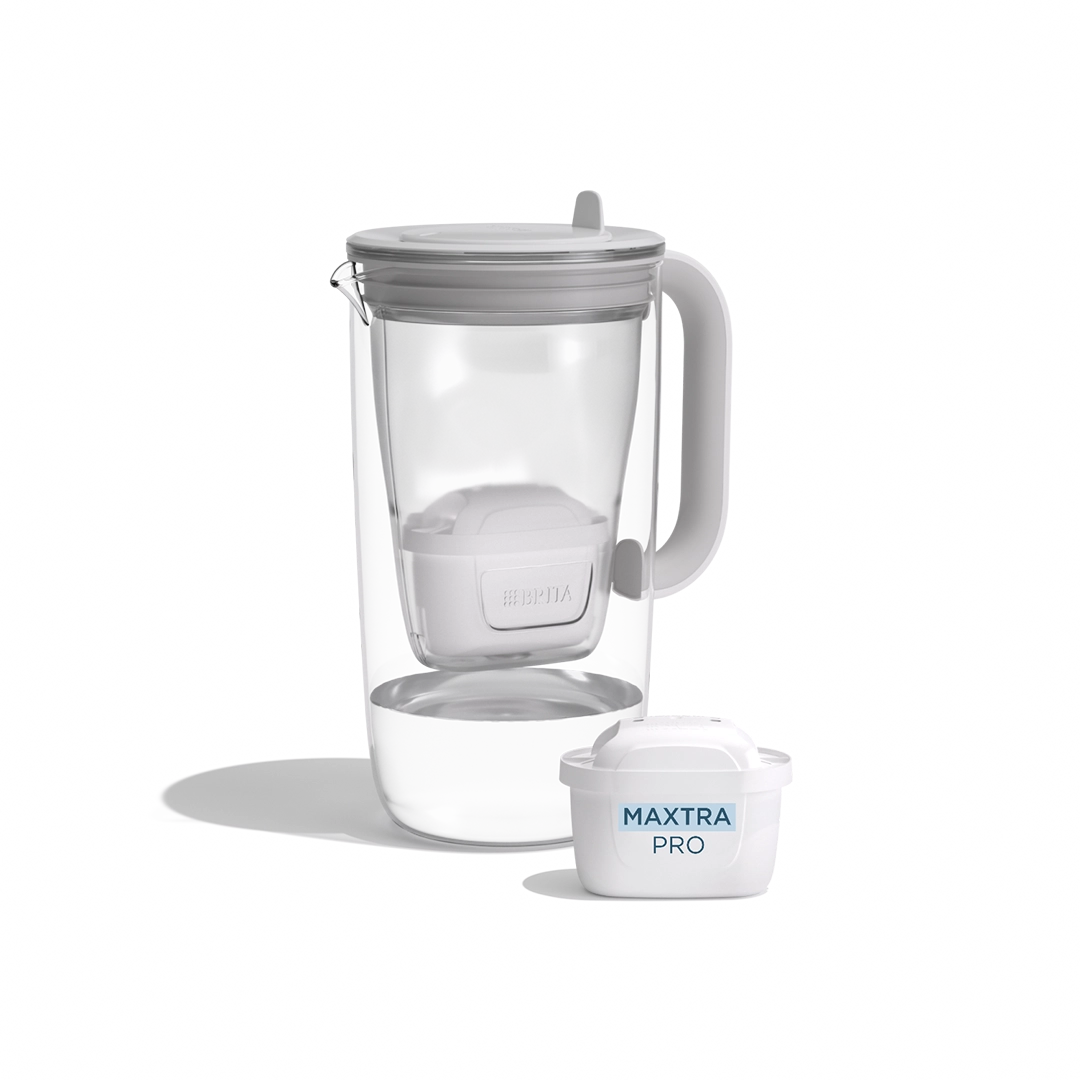 A water filter glass jug in grey on a white background