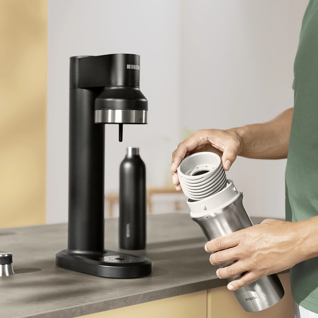 Person assembling a sodaTRIO bottle with container base