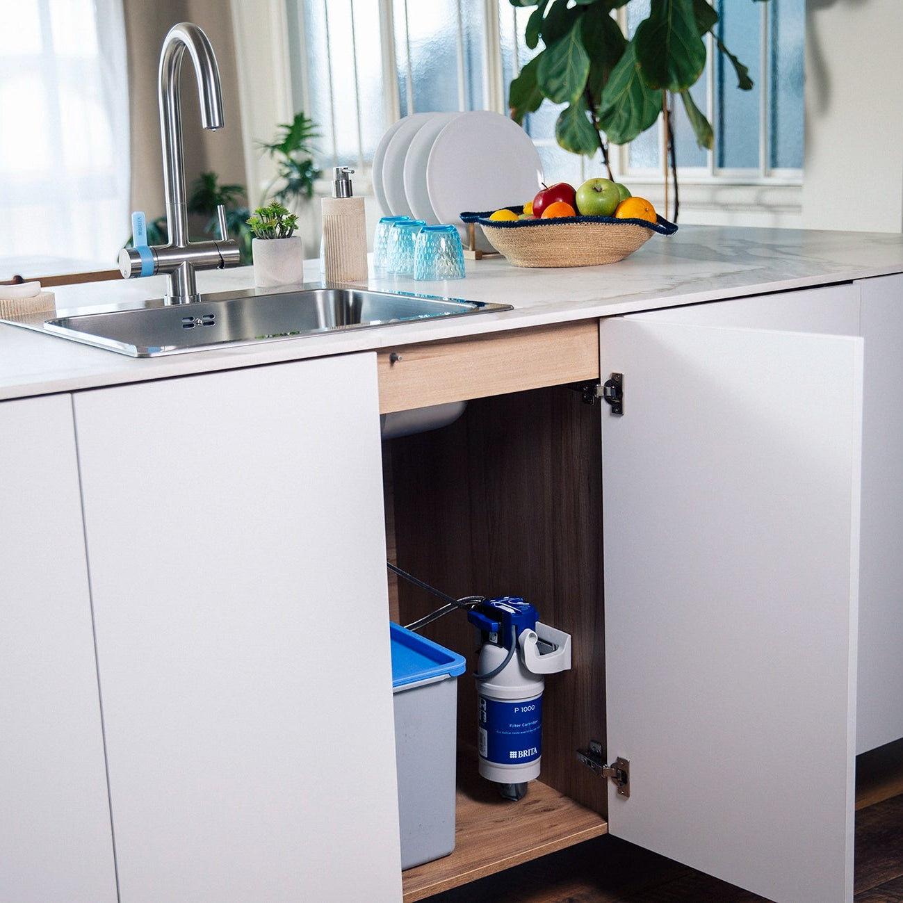 Modern kitchen with open cabinet and BRITA P 1000 water filter.