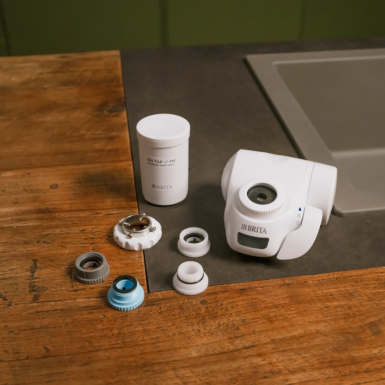 Installation kit for the BRITA ON TAP Pro displayed on a kitchen countertop.